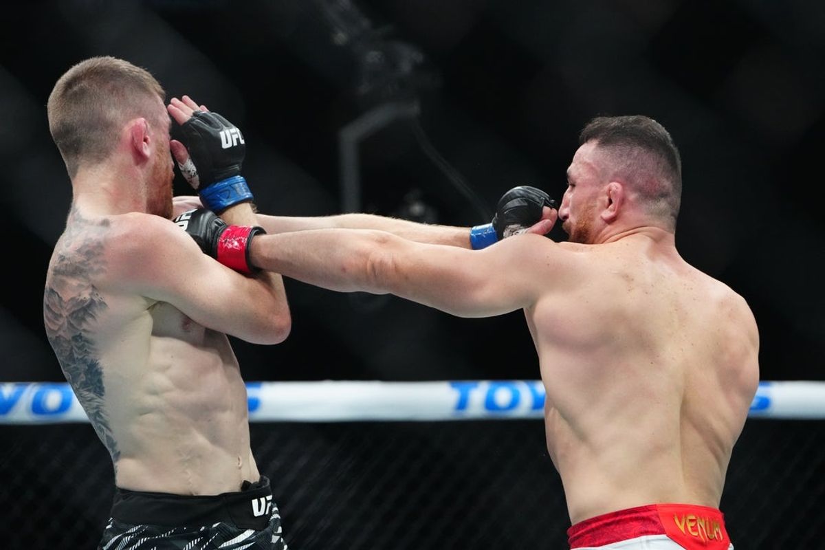 Oct 4, 2025; Las Vegas, Nevada, UNITED STATES; Merab Dvalishvili (red gloves) fights Cory Sandhagen (blue gloves) during UFC 320 at T-Mobile Arena. Mandatory Credit: Stephen R. Sylvanie-Imagn Images