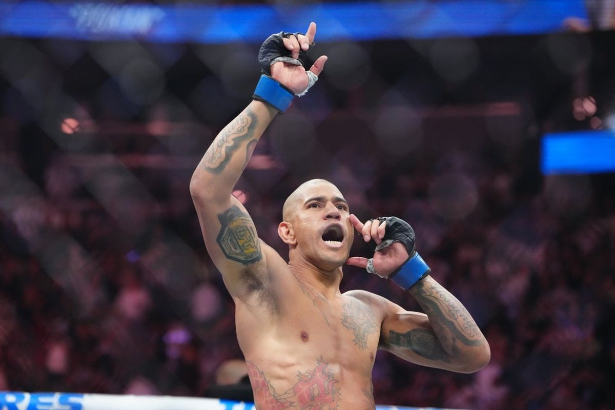 Oct 4, 2025; Las Vegas, Nevada, UNITED STATES; Alex Pereira (blue gloves) reacts after the fight against Magomed Ankalaev (red gloves) during UFC 320 at T-Mobile Arena. Mandatory Credit: Stephen R. Sylvanie-Imagn Images