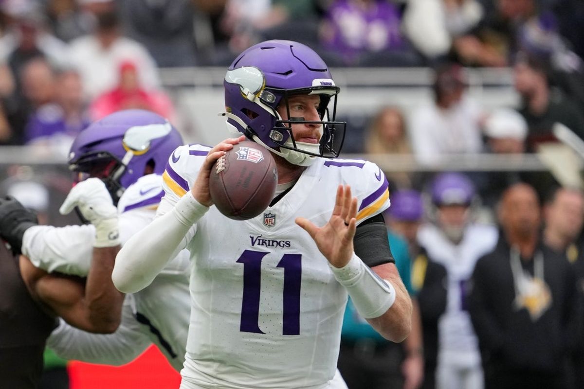 Oct 5, 2025; Tottenham, United Kingdom; Minnesota Vikings quarterback Carson Wentz (11) looks to pass the ball against the Cleveland Browns during the third quarter of an NFL International Series game at Tottenham Hotspur Stadium. Mandatory Credit: Kirby Lee-Imagn Images