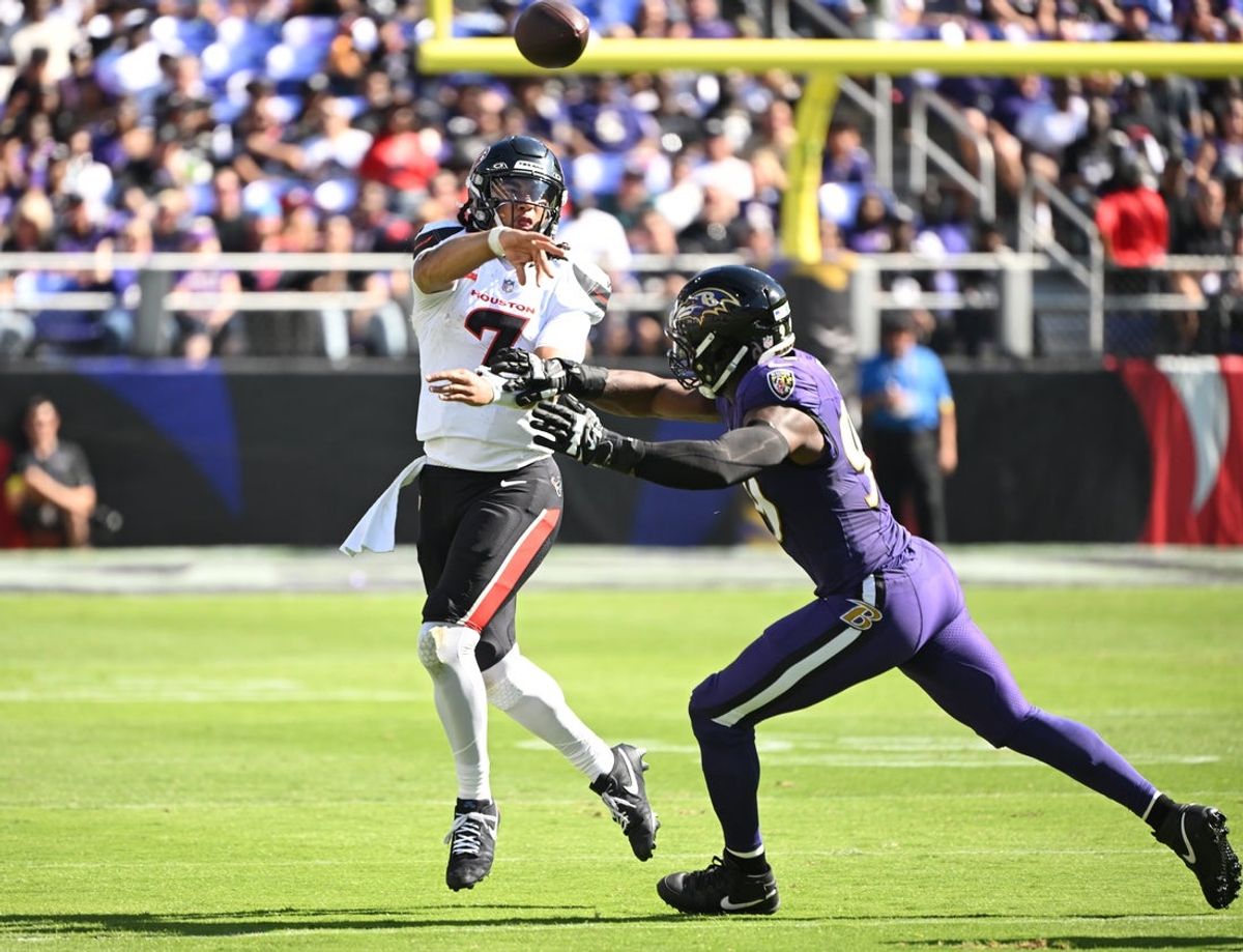 Oct 5, 2025; Baltimore, Maryland, USA; Houston Texans quarterback C.J. Stroud (7) throws past Baltimore Ravens linebacker Odafe Oweh (99) during the second quarter at M&T Bank Stadium. Mandatory Credit: Rafael Suanes-Imagn Images