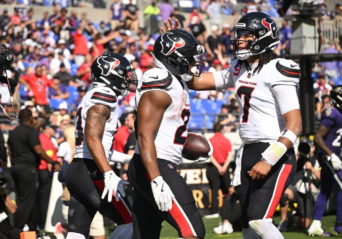 Oct 5, 2025; Baltimore, Maryland, USA; Houston Texans running back Nick Chubb (21) celebrates with quarterback C.J. Stroud (7) after scoring a touchdown during the third quarter against the Baltimore Ravens at M&T Bank Stadium. Mandatory Credit: Rafael Suanes-Imagn Images