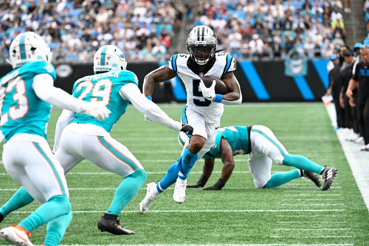 Oct 5, 2025; Charlotte, North Carolina, USA; Carolina Panthers running back Rico Dowdle (5) with the ball as Miami Dolphins free safety Minkah Fitzpatrick (29) defends in the second quarter at Bank of America Stadium. Mandatory Credit: Bob Donnan-Imagn Images