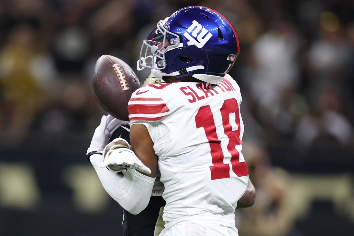 Oct 5, 2025; New Orleans, Louisiana, USA; New York Giants wide receiver Darius Slayton (18) reaches for the ball against New Orleans Saints cornerback Isaac Yiadom (26) during the first half at Caesars Superdome. Mandatory Credit: Stephen Lew-Imagn Images