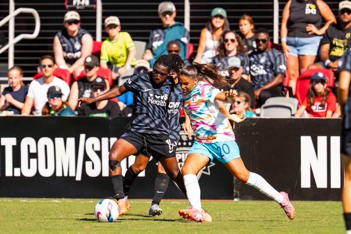Oct 5, 2025; Washington, District of Columbia, USA; Washington Spirit forward Rosemonde Kouassi (19) and San Diego Wave FC forward Delphine Cascarino (20) battle for the ball in the second half at Audi Field. Mandatory Credit: Emily Faith Morgan-Imagn Images