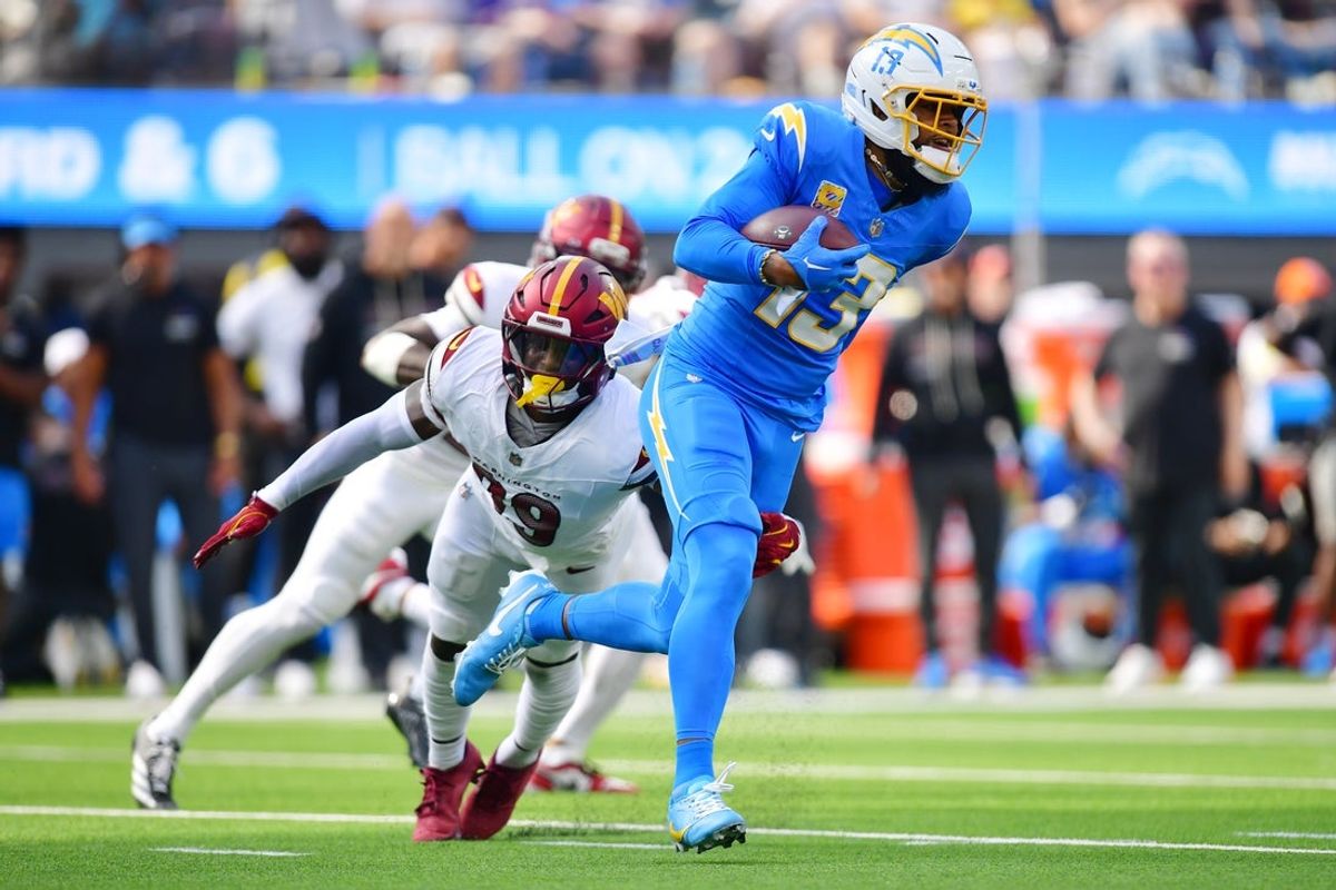 Oct 5, 2025; Inglewood, California, USA; Los Angeles Chargers wide receiver Keenan Allen (13) runs against Washington Commanders safety Jeremy Reaves (39) in the first half  at SoFi Stadium. Mandatory Credit: Gary A. Vasquez-Imagn Images