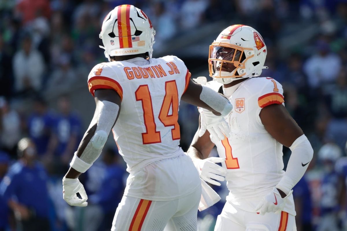 Oct 5, 2025; Seattle, Washington, USA;  Tampa Bay Buccaneers wide receiver Chris Godwin Jr. (14) and running back Rachaad White (1) react after a first down against the Seattle Seahawks during the first half at Lumen Field. Mandatory Credit: Joe Nicholson-Imagn Images
