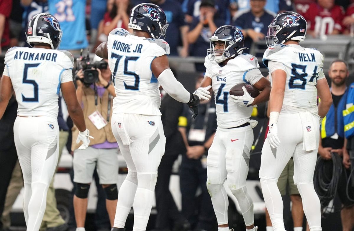 Tennessee Titans receiver Tyler Lockett (4) celebrates with his teammates after falling on a fumble to score a touchdown against the Arizona Cardinals at State Farm Stadium in Glendale on Oct. 5, 2025.