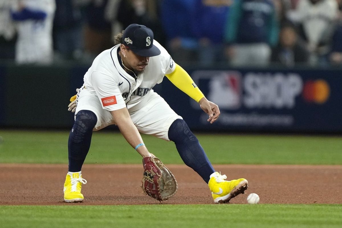 Oct 5, 2025; Seattle, Washington, USA; Seattle Mariners first baseman Josh Naylor (12) field a ball in the seventh inning against the Detroit Tigers during game two of the ALDS round for the 2025 MLB playoffs at T-Mobile Park. Mandatory Credit: Stephen Brashear-Imagn Images