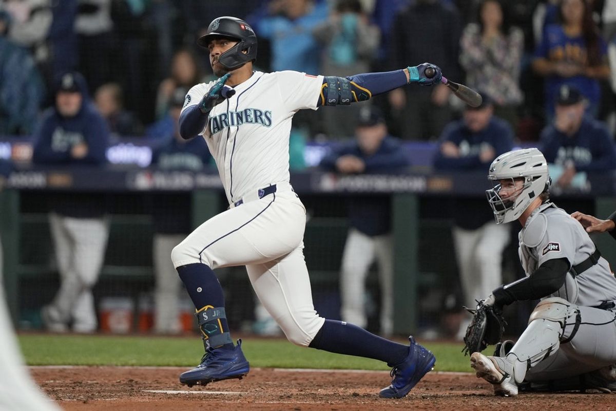 Oct 5, 2025; Seattle, Washington, USA; Seattle Mariners center fielder Julio Rodriguez (44) hits an RBI double against the Detroit Tigers in the eighth inning during game two of the ALDS round for the 2025 MLB playoffs at T-Mobile Park. Mandatory Credit: Stephen Brashear-Imagn Images