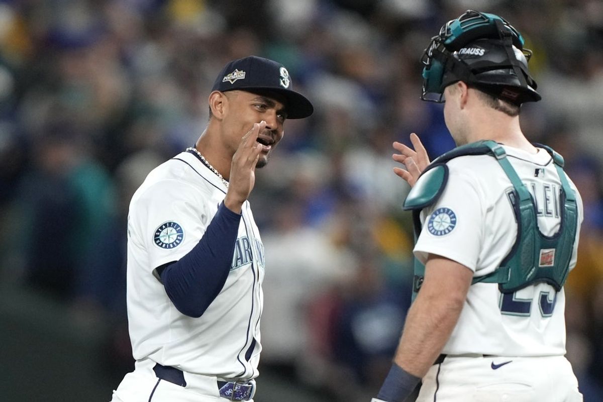 Oct 5, 2025; Seattle, Washington, USA; Seattle Mariners center fielder Julio Rodriguez (44) and catcher Cal Raleigh (29) celebrate after defeating the Denver Broncos in game two of the ALDS round for the 2025 MLB playoffs at T-Mobile Park. Mandatory Credit: Stephen Brashear-Imagn Images
