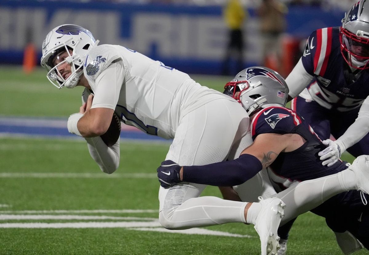 Buffalo Bills quarterback Josh Allen, running with the ball, gets brought down by New England Patriots linebacker Robert Spillane during first half action at Highmark Stadium in Orchard Park on Oct. 5, 2025.
