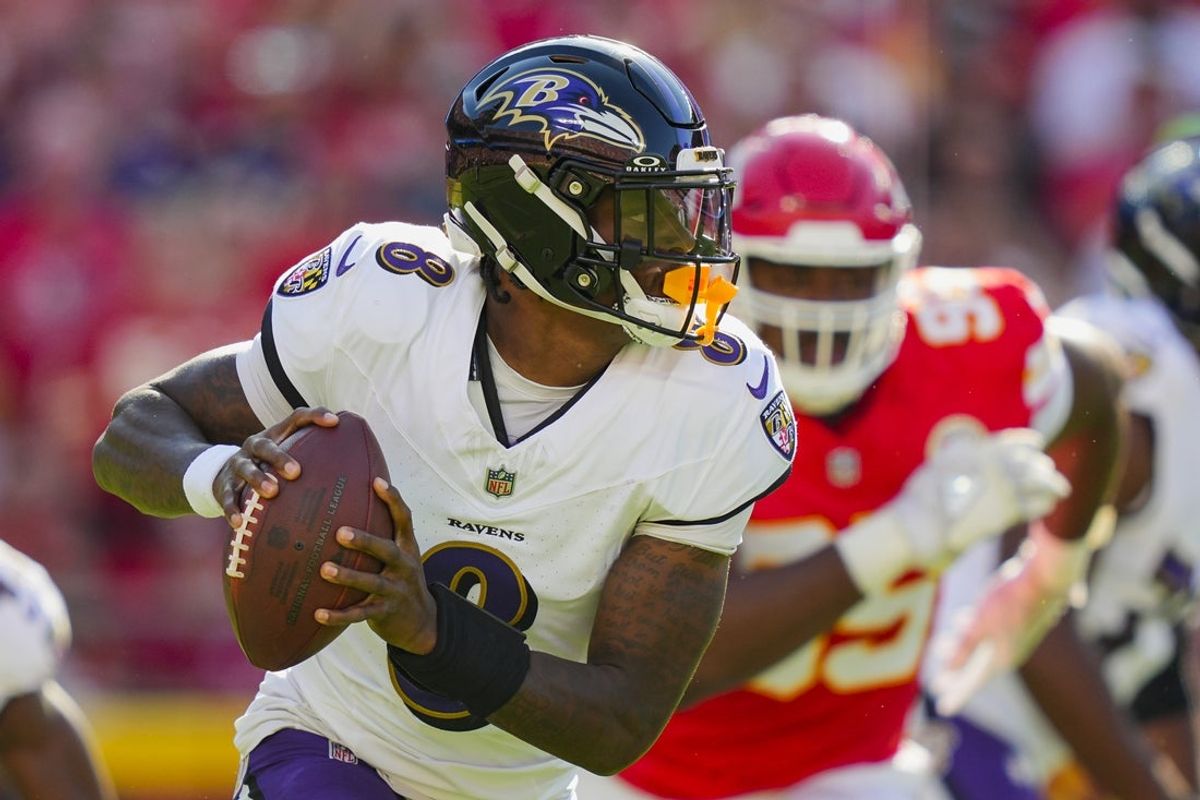 Sep 28, 2025; Kansas City, Missouri, USA; Baltimore Ravens quarterback Lamar Jackson (8) rolls out to pass during the first half against the Kansas City Chiefs at GEHA Field at Arrowhead Stadium. Mandatory Credit: Jay Biggerstaff-Imagn Images