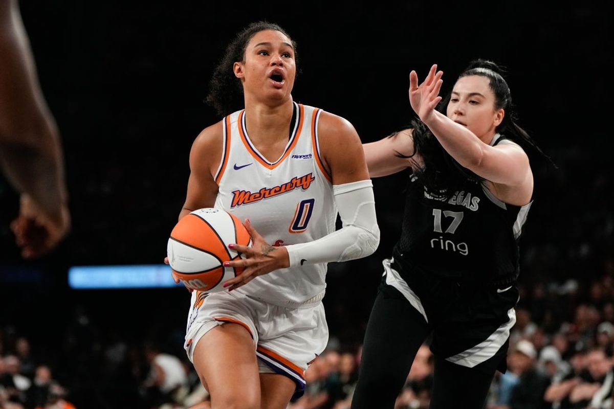 Oct 5, 2025; Las Vegas, Nevada, USA; Phoenix Mercury forward Satou Sabally (0) drives the ball against Megan Gustafson (17) during the second quarter of game two of the 2025 WNBA Finals at Michelob Ultra Arena. Mandatory Credit: Lucas Peltier-Imagn Images