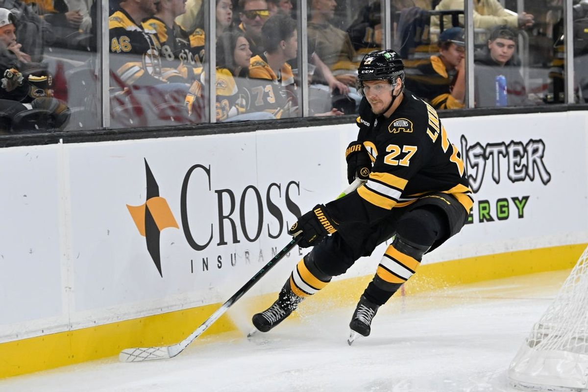 Sep 29, 2025; Boston, Massachusetts, USA; Boston Bruins defenseman Hampus Lindholm (27) shields the puck during the second period against the Philadelphia Flyers at TD Garden. Mandatory Credit: Eric Canha-Imagn Images