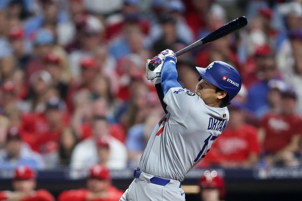 Oct 6, 2025; Philadelphia, Pennsylvania, USA; Los Angeles Dodgers designated hitter Shohei Ohtani (17) hits an RBI single against the Philadelphia Phillies in the seventh inning during game two of the NLDS round for the 2025 MLB playoffs at Citizens Bank Park. Mandatory Credit: Bill Streicher-Imagn Images