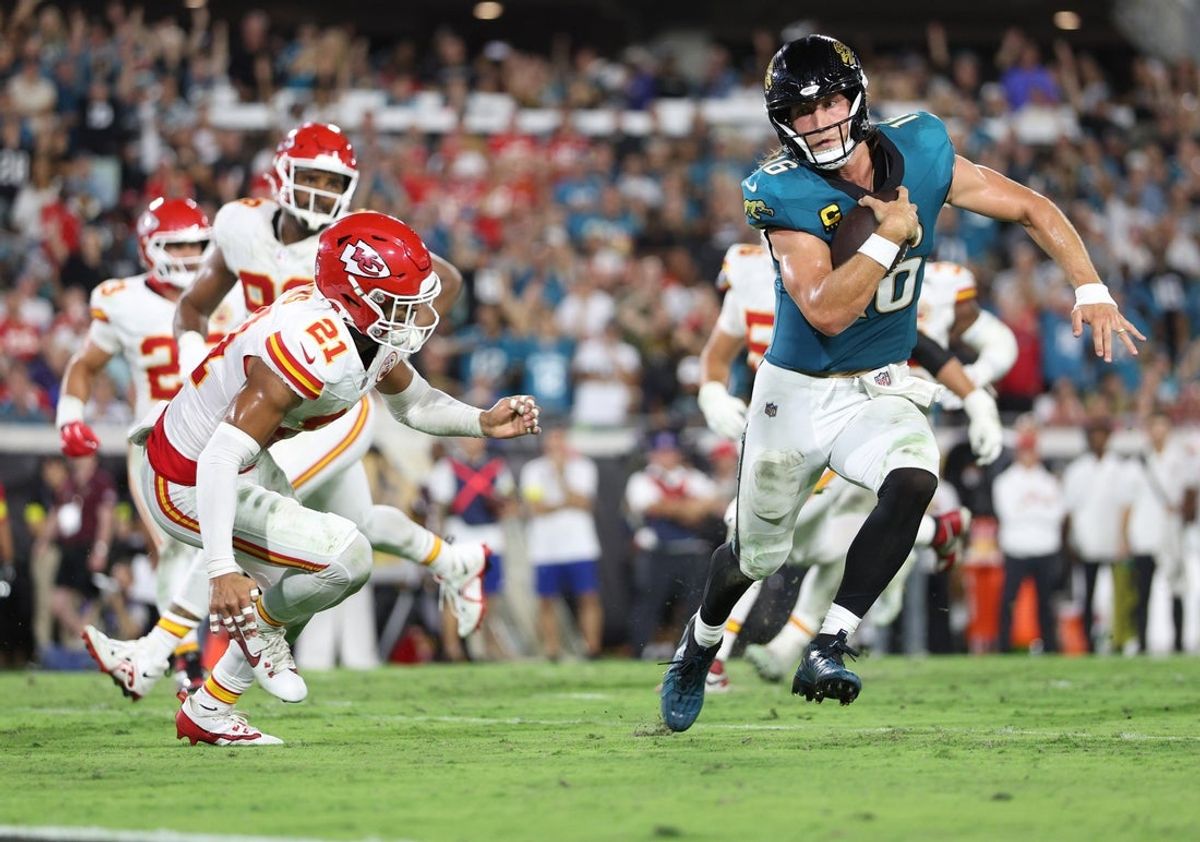 Oct 6, 2025; Jacksonville, Florida, USA; Jacksonville Jaguars quarterback Trevor Lawrence (16) scores a touchdown against Kansas City Chiefs safety Jaden Hicks (21) during the second half at EverBank Stadium. Mandatory Credit: Nathan Ray Seebeck-Imagn Images