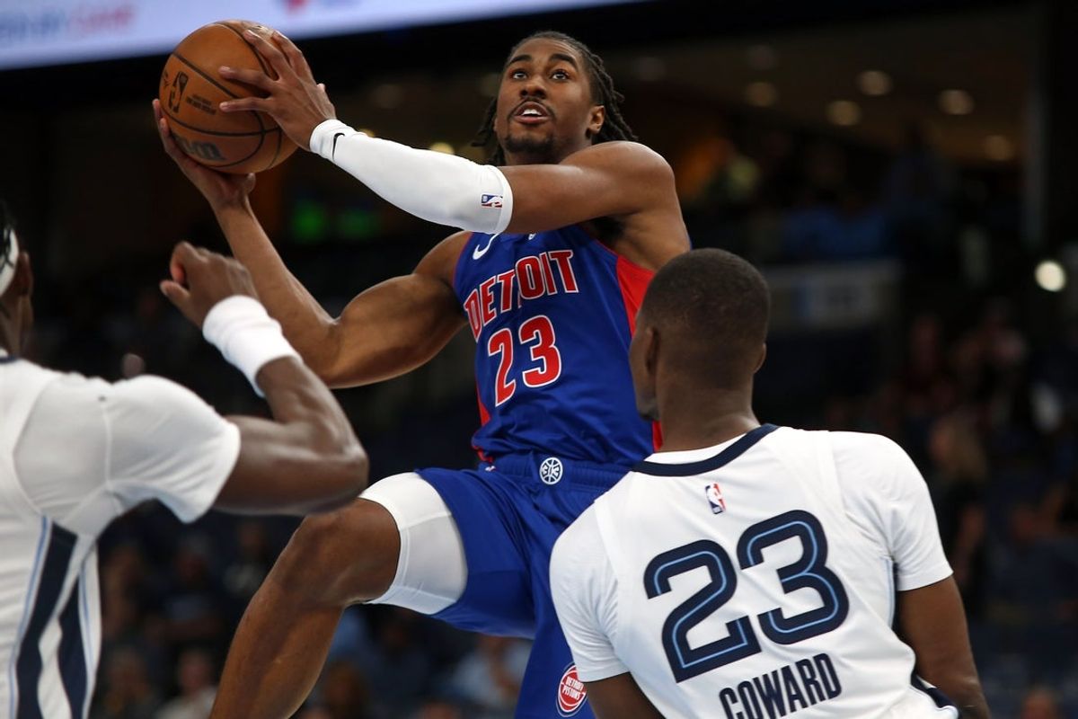 Oct 6, 2025; Memphis, Tennessee, USA; Detroit Pistons guard Jaden Ivey (23) drives to the basket as Memphis Grizzlies forward Cedric Coward (23) defends during the second quarter at FedExForum. Mandatory Credit: Petre Thomas-Imagn Images