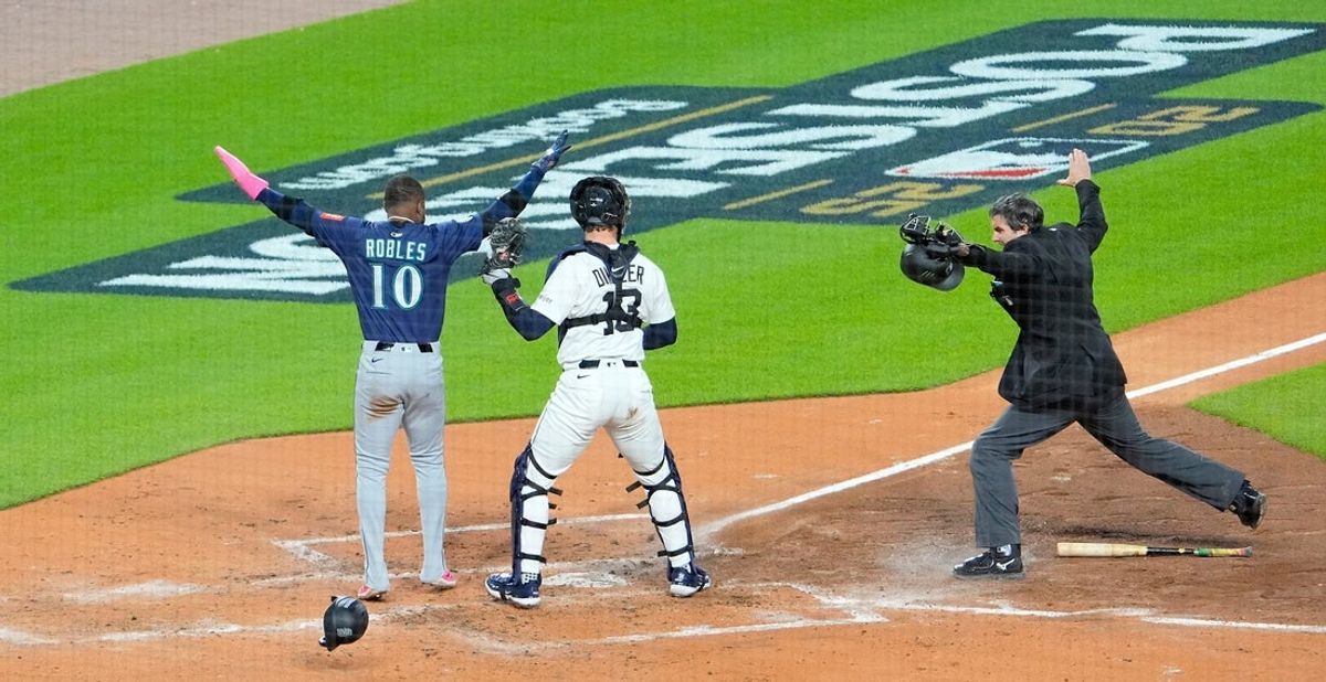 Seattle Mariners Victor Robles is called safe at home plate when Detroit Tigers Dillion Dingler was late with the tag during game 3 of the American League Division Series at Comerica Park in Detroit on Tuesday, Oct. 7, 2025.