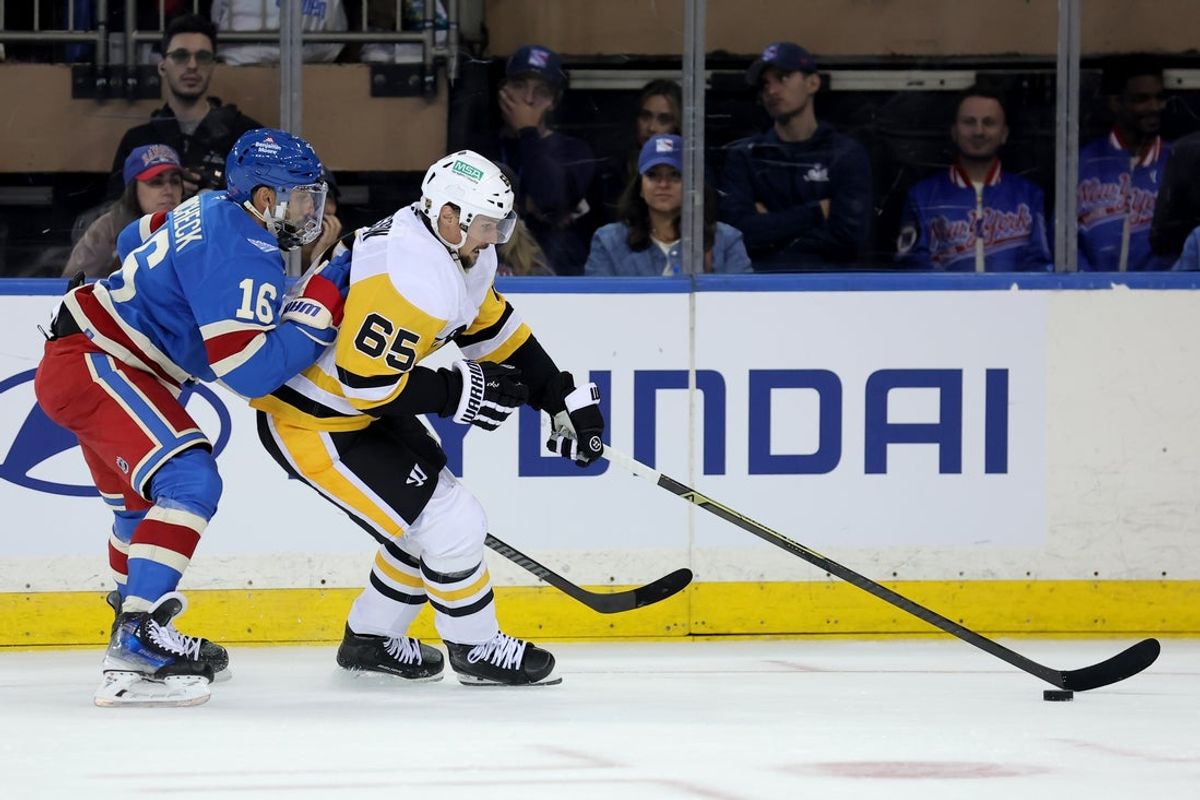 Oct 7, 2025; New York, New York, USA; Pittsburgh Penguins defenseman Erik Karlsson (65) skates with the puck against New York Rangers center Vincent Trocheck (16) during the third period at Madison Square Garden. Mandatory Credit: Brad Penner-Imagn Images