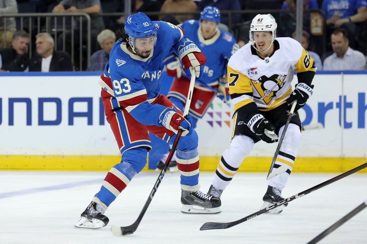 Oct 7, 2025; New York, New York, USA; New York Rangers center Mika Zibanejad (93) takes a shot in front of Pittsburgh Penguins right wing Rickard Rakell (67) during the third period at Madison Square Garden. Mandatory Credit: Brad Penner-Imagn Images