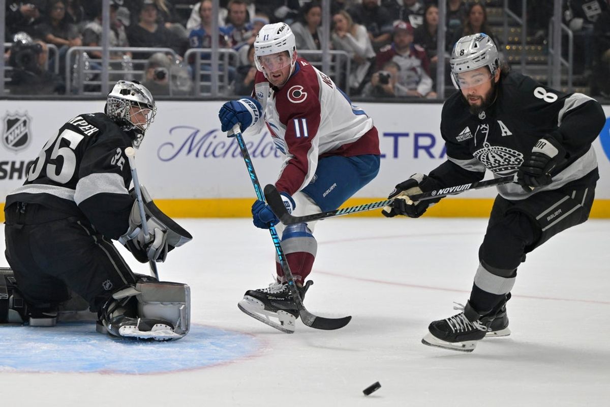 Oct 7, 2025; Los Angeles, California, USA;  Los Angeles Kings goaltender Darcy Kuemper (35) blocks a shot by Colorado Avalanche center Brock Nelson (11) as Los Angeles Kings defenseman Drew Doughty (8) chases down the puck during the first period at Crypto.com Arena. Mandatory Credit: Jayne Kamin-Oncea-Imagn Images