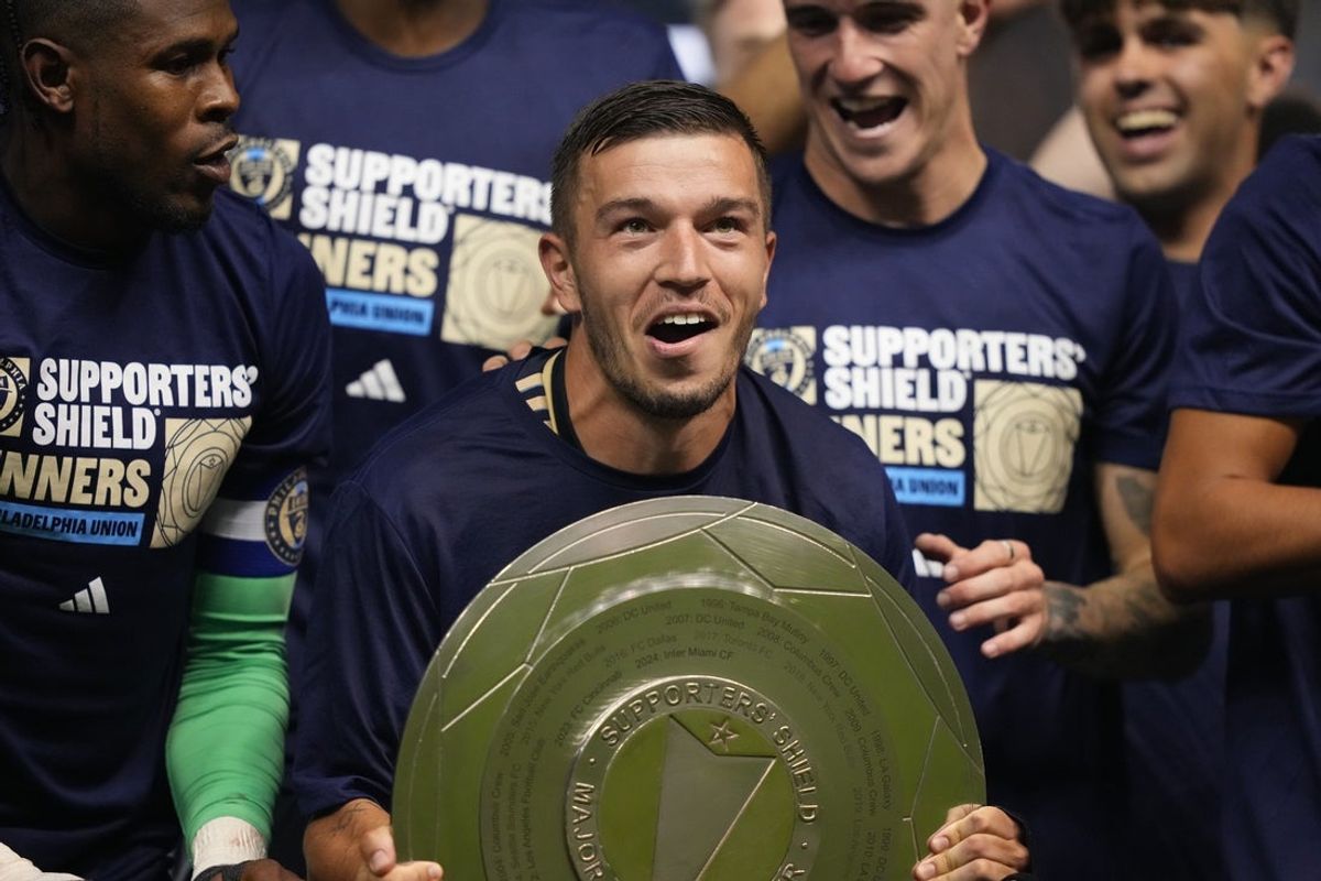 Oct 4, 2025; Chester, Pennsylvania, USA; Philadelphia Union defender Kai Wagner (27) lifts the 2025 MLS Supporters' Shield after the game against New York City FC at Subaru Park. Mandatory Credit: Kyle Ross-Imagn Images