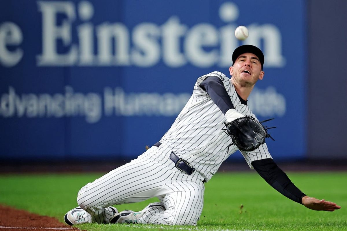 Oct 8, 2025; Bronx, New York, USA; New York Yankees left fielder Cody Bellinger (35) slides to makes a catch during the first inning against the Toronto Blue Jays during game four of the ALDS round for the 2025 MLB playoffs at Yankee Stadium. Mandatory Credit: Brad Penner-Imagn Images
