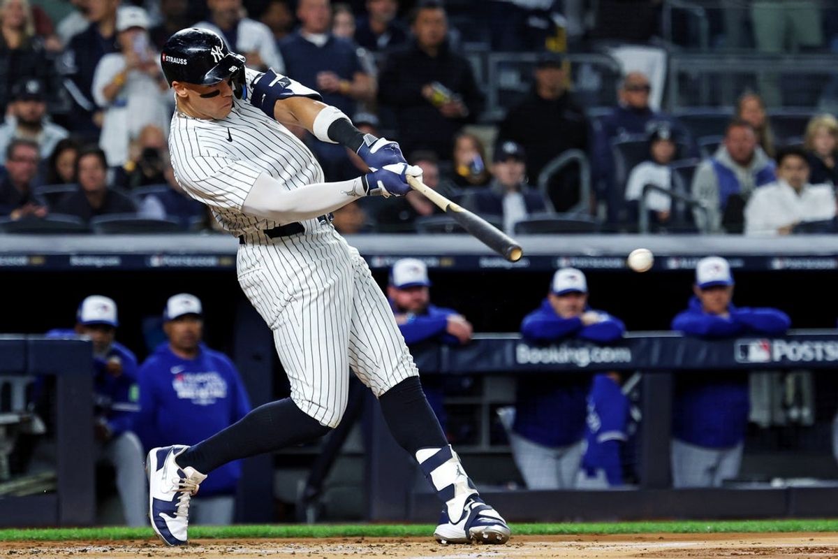 Oct 8, 2025; Bronx, New York, USA; New York Yankees right fielder Aaron Judge (99) hits a single during the first inning against the Toronto Blue Jays during game four of the ALDS round for the 2025 MLB playoffs at Yankee Stadium. Mandatory Credit: Vincent Carchietta-Imagn Images