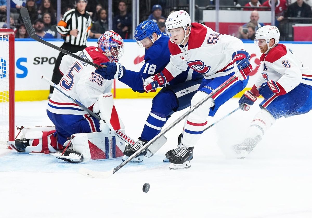 Oct 8, 2025; Toronto, Ontario, CAN; Toronto Maple Leafs center Steven Lorentz (18) battles for the puck with Montreal Canadiens defenseman Noah Dobson (53) during the third period at Scotiabank Arena. Mandatory Credit: Nick Turchiaro-Imagn Images
