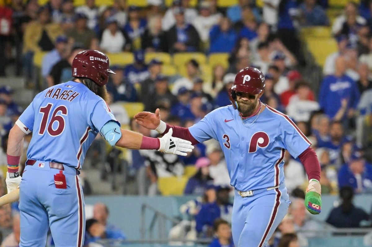 Oct 8, 2025; Los Angeles, California, USA; Philadelphia Phillies first baseman Bryce Harper (3) celebrates with Philadelphia Phillies center fielder Brandon Marsh (16) after scoring on a Los Angeles Dodgers throwing error during the fourth inning during game three of the NLDS round for the 2025 MLB playoffs at Dodger Stadium. Mandatory Credit: Jayne Kamin-Oncea-Imagn Images