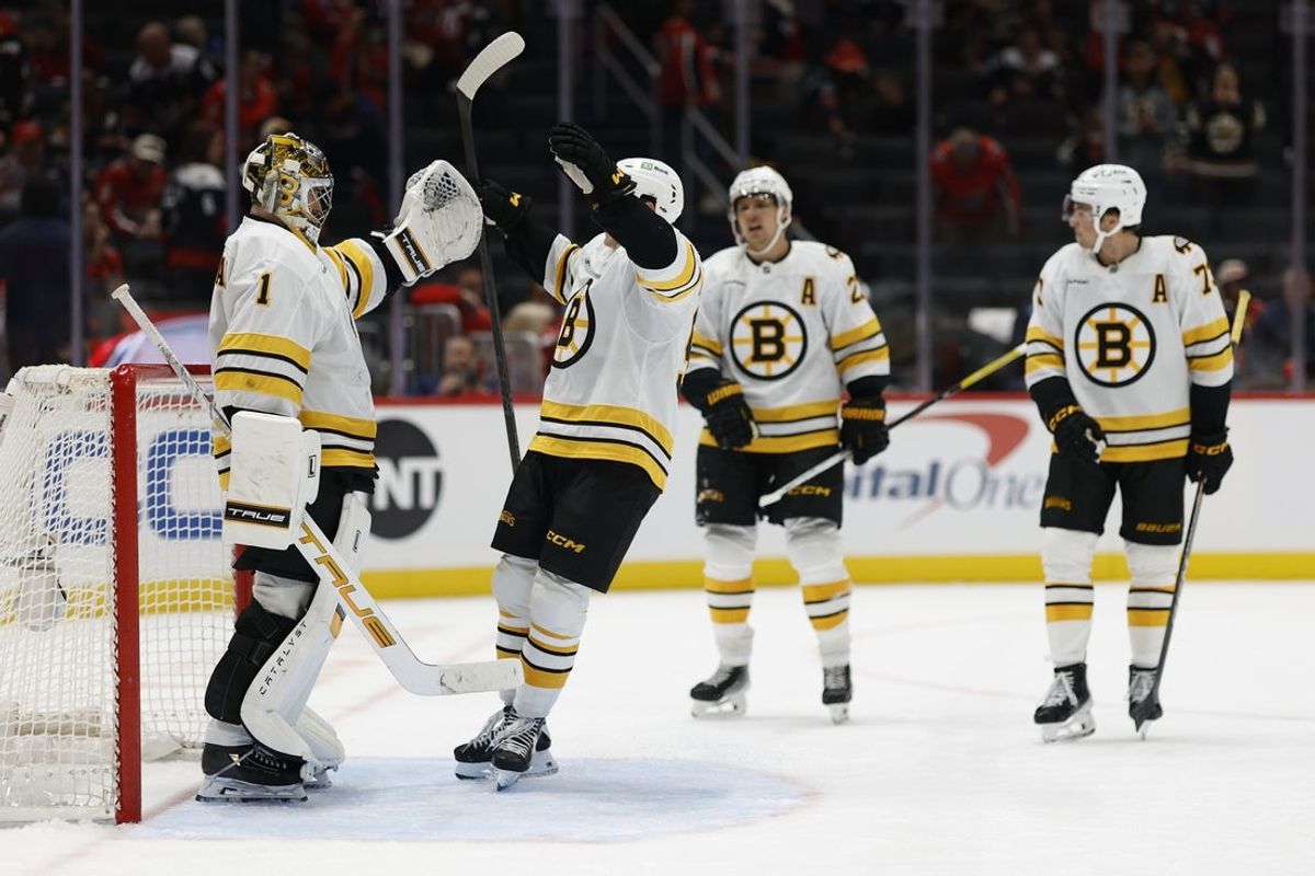 Oct 8, 2025; Washington, District of Columbia, USA; Boston Bruins goaltender Jeremy Swayman (1) celebrates with teammates after their game against the Washington Capitals at Capital One Arena. Mandatory Credit: Geoff Burke-Imagn Images