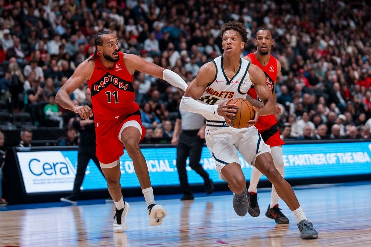 Oct 6, 2025; Vancouver, British Columbia, CAN; Toronto Raptors forward Olivier Sarr (11) defends against Denver Nuggets forward Kessler Edwards (20) in the second half at Rogers Arena. Mandatory Credit: Bob Frid-Imagn Images