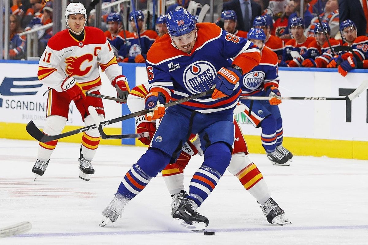 Oct 8, 2025; Edmonton, Alberta, CAN;  Edmonton Oilers forward David Tomasek (86) protects the puck from from Calgary Flames forward Connor Zary (47) during the third period at Rogers Place. Mandatory Credit: Perry Nelson-Imagn Images