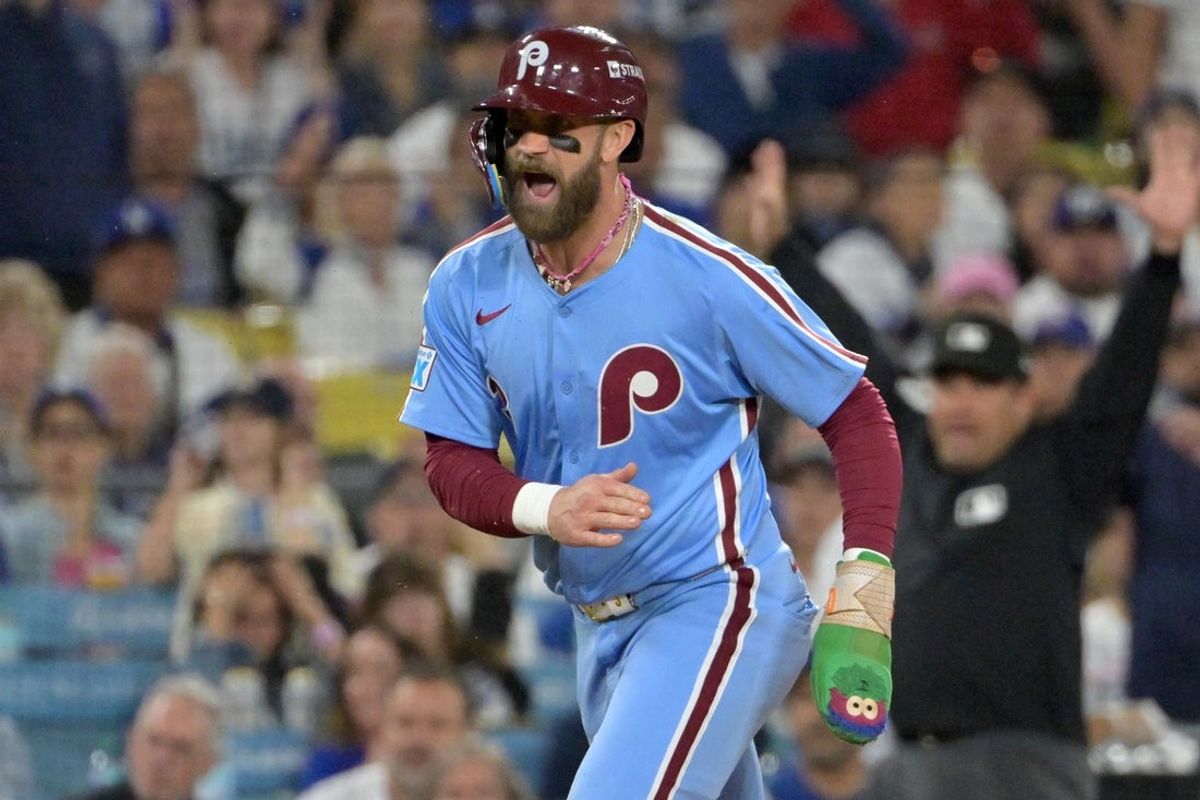 Oct 8, 2025; Los Angeles, California, USA; Philadelphia Phillies first baseman Bryce Harper (3) reacts as he scores a run during the fourth inning in game three of the NLDS against the Los Angeles Dodgers during the 2025 MLB playoffs at Dodger Stadium. Mandatory Credit: Jayne Kamin-Oncea-Imagn Images