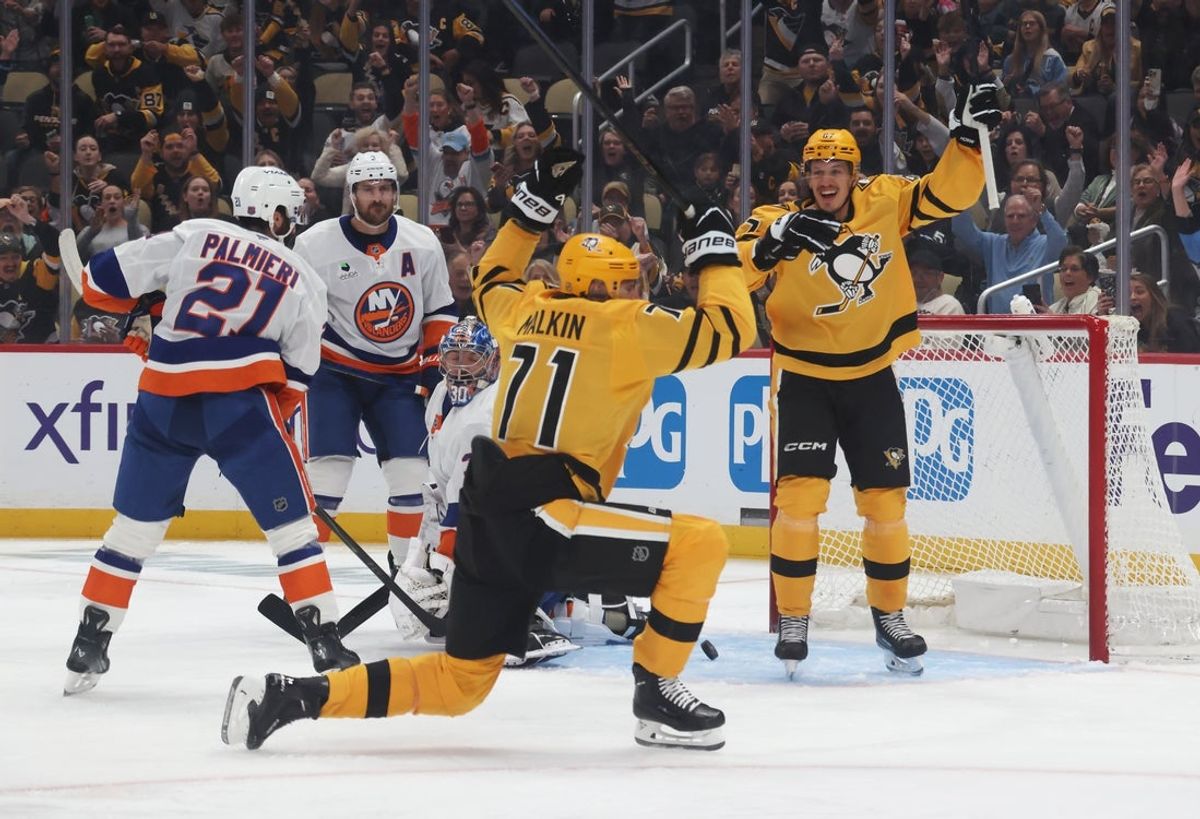 Oct 9, 2025; Pittsburgh, Pennsylvania, USA;  Pittsburgh Penguins right wing Rickard Rakell (67) and center Evgeni Malkin (71) react after a goal by Malkin against the New York Islanders during the first period at PPG Paints Arena. Mandatory Credit: Charles LeClaire-Imagn Images