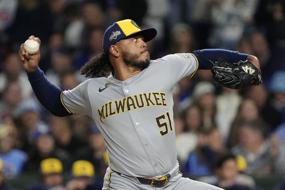 Oct 9, 2025; Chicago, Illinois, USA; Milwaukee Brewers pitcher Freddy Peralta (51) throws pitch against the Chicago Cubs during the first inning for game four of the NLDS round for the 2025 MLB playoffs at Wrigley Field. Mandatory Credit: David Banks-Imagn Images