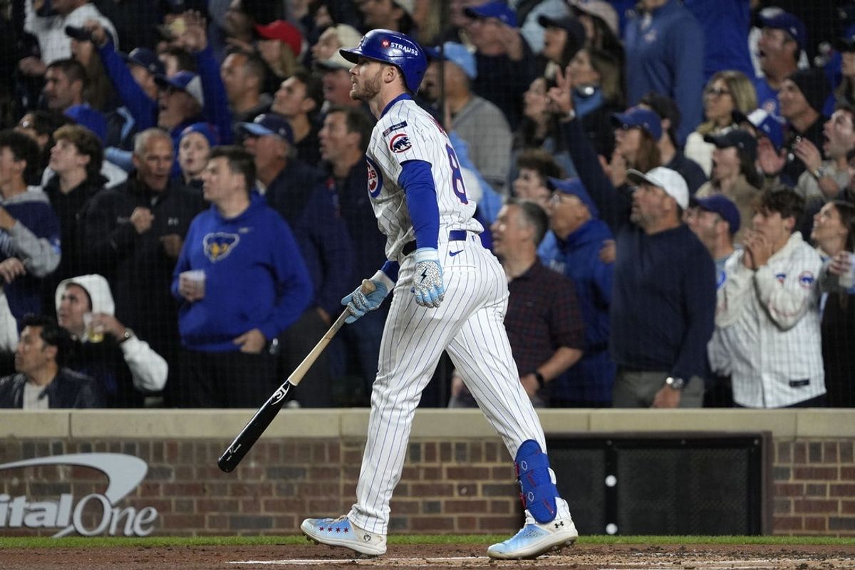 Oct 9, 2025; Chicago, Illinois, USA; Chicago Cubs left fielder Ian Happ (8) hits a three run home run against the Milwaukee Brewers during the first inning for game four of the NLDS round for the 2025 MLB playoffs at Wrigley Field. Mandatory Credit: David Banks-Imagn Images