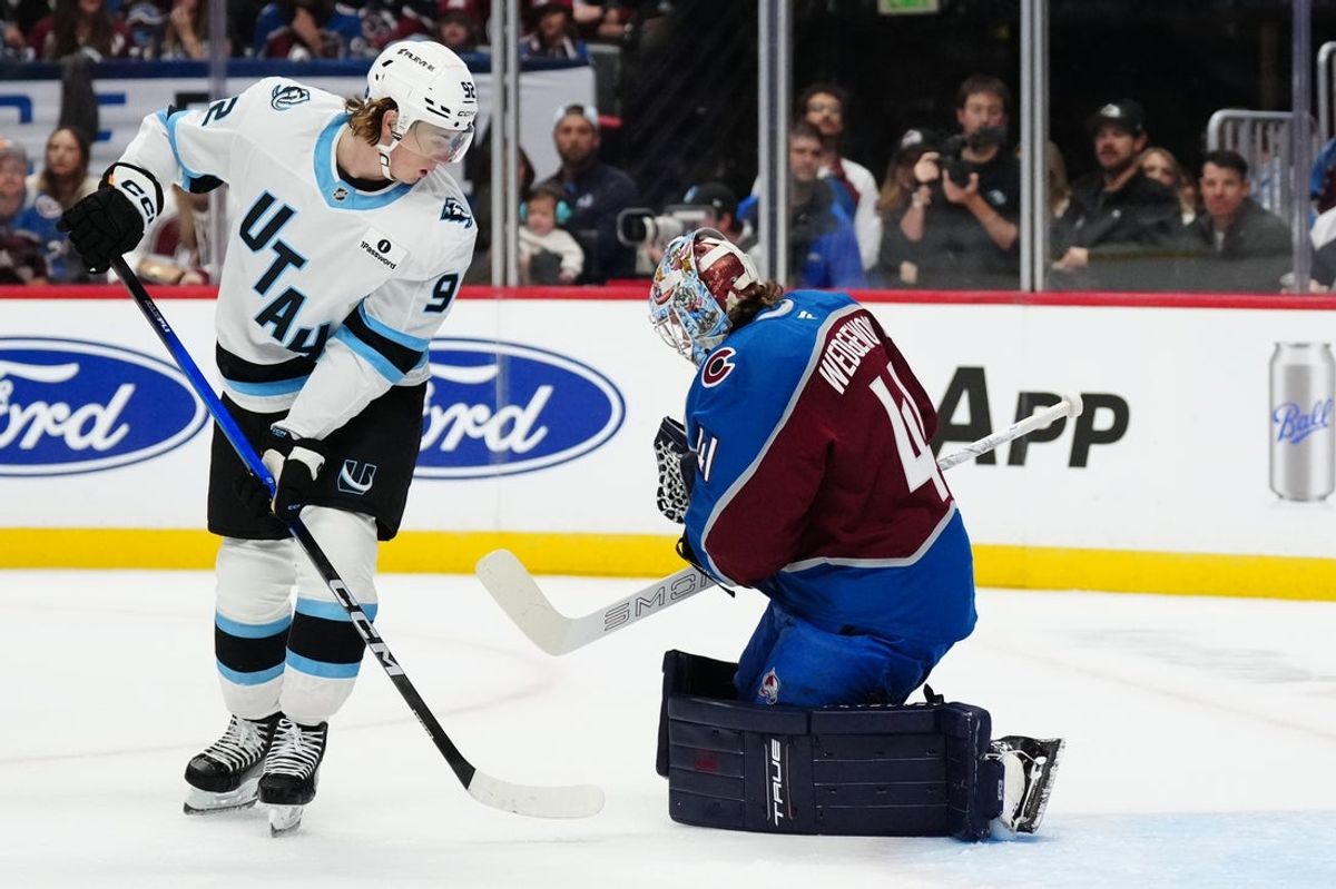 Oct 9, 2025; Denver, Colorado, USA; Utah Mammoth center Logan Cooley (92) looks for a rebound on Colorado Avalanche goaltender Scott Wedgewood (41) in the first period at Ball Arena. Mandatory Credit: Ron Chenoy-Imagn Images