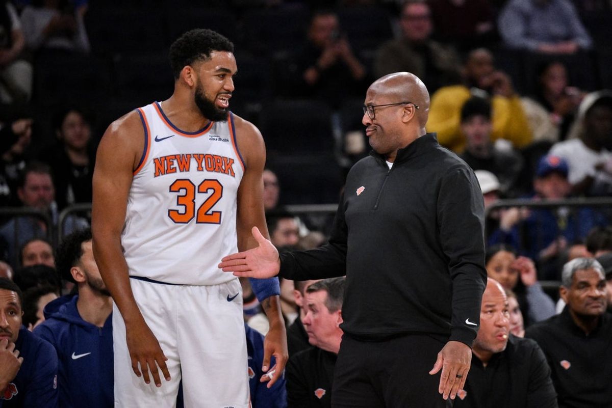 Oct 9, 2025; New York, New York, USA; New York Knicks head coach Mike Brown reacts as he talks with center/forward Karl-Anthony Towns (32) during the first half against the Minnesota Timberwolves at Madison Square Garden. Mandatory Credit: John Jones-Imagn Images