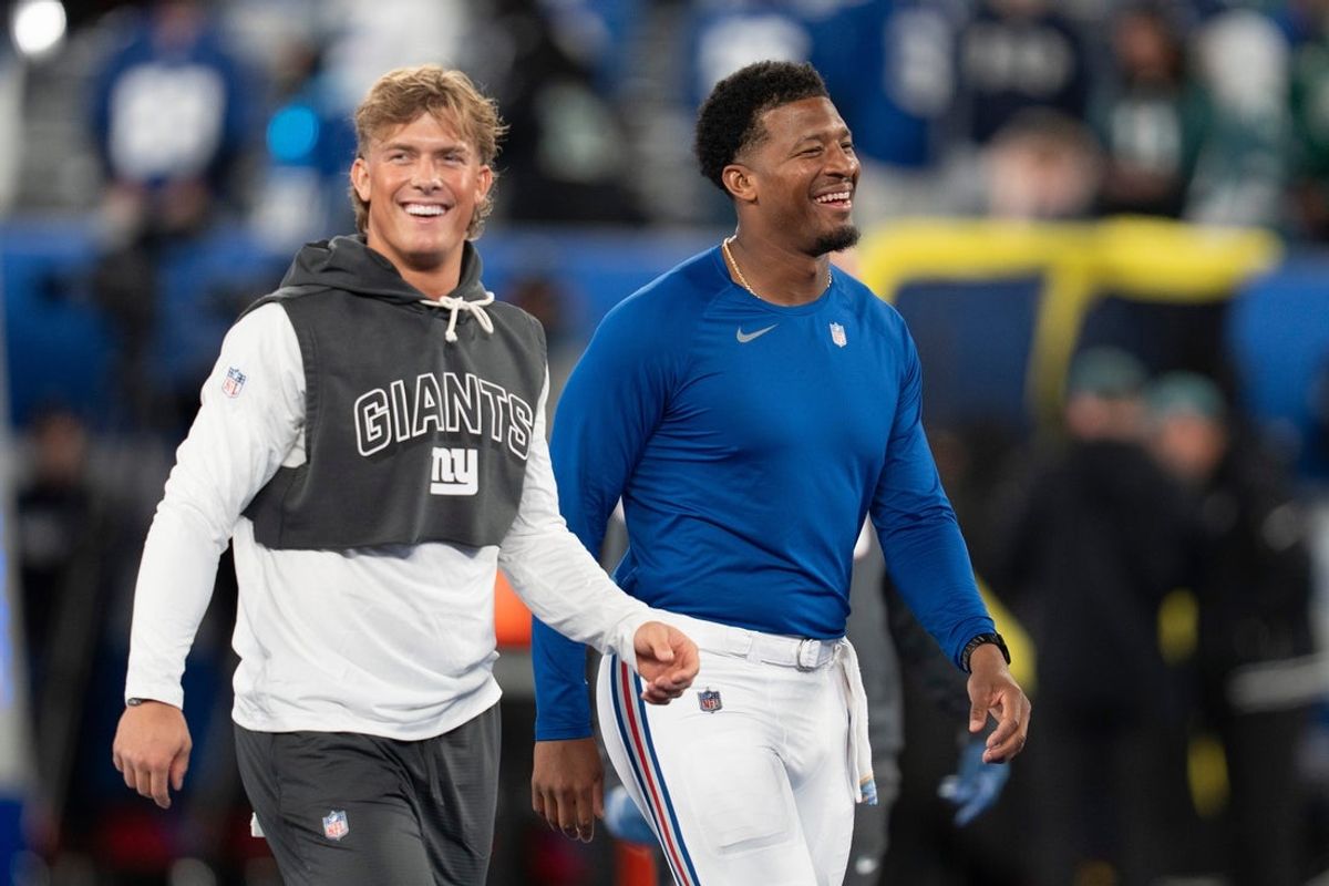 New York Giants quarterback Jaxson Dart (6) and New York Giants quarterback Jameis Winston (19) smile during warmups before a Thursday Night Football game between the New York Giants and the Philadelphia Eagles at MetLife Stadium in East Rutherford on Oct. 9, 2025.