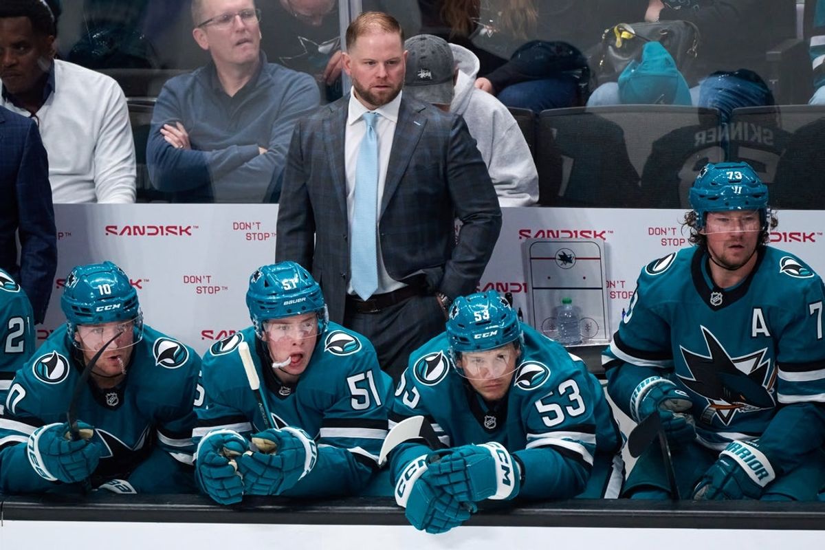 Oct 9, 2025; San Jose, California, USA; San Jose Sharks head coach Ryan Warsofsky watches game play against the Vegas Golden Knights with center Ty Dellandrea (10), right wing Collin Graf (51), left wing Jeff Skinner (53) and center Tyler Toffoli (73) during the second period at SAP Center at San Jose. Mandatory Credit: Robert Edwards-Imagn Images