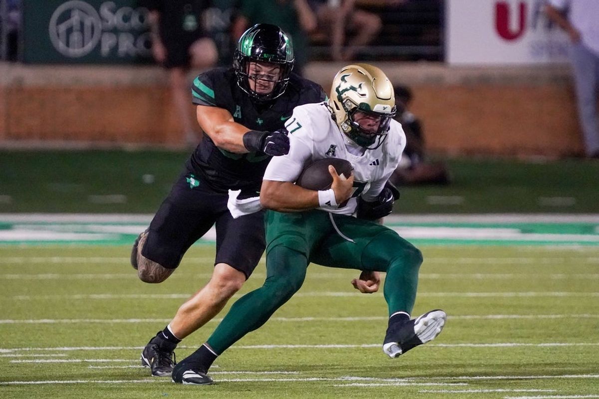 Oct 10, 2025; Denton, Texas, USA; South Florida Bulls quarterback Byrum Brown (17) is tackled by North Texas Mean Green defensive lineman Ethan Day (90) during the first half of a game at DATCU Stadium. Mandatory Credit: Raymond Carlin III-Imagn Images