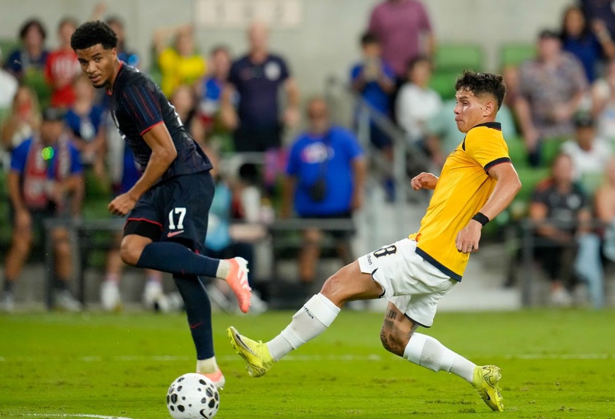 Oct 10, 2025; Austin, Texas, USA; United States midfielder Malik Tillman (17) passes the ball against Ecuador midfielder Jordy Alcivar (8) to assist on a goal in the second half at Q2 Stadium. Mandatory Credit: Scott Coleman-Imagn Images