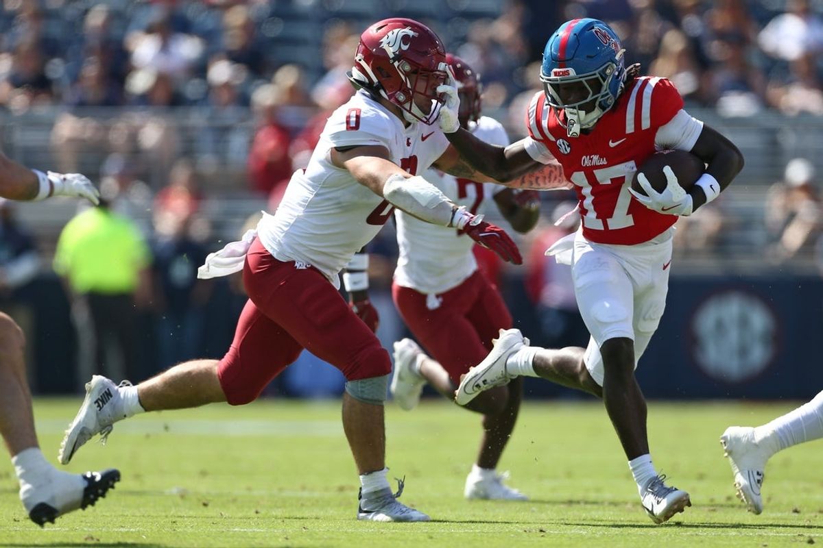 Oct 11, 2025; Oxford, Mississippi, USA; Mississippi Rebels wide receiver Winston Watkins (17) runs after a catch as Washington State Cougars linebacker Anthony Palano (0) attempts to make the tackle during the first quarter at Vaught-Hemingway Stadium. Mandatory Credit: Petre Thomas-Imagn Images