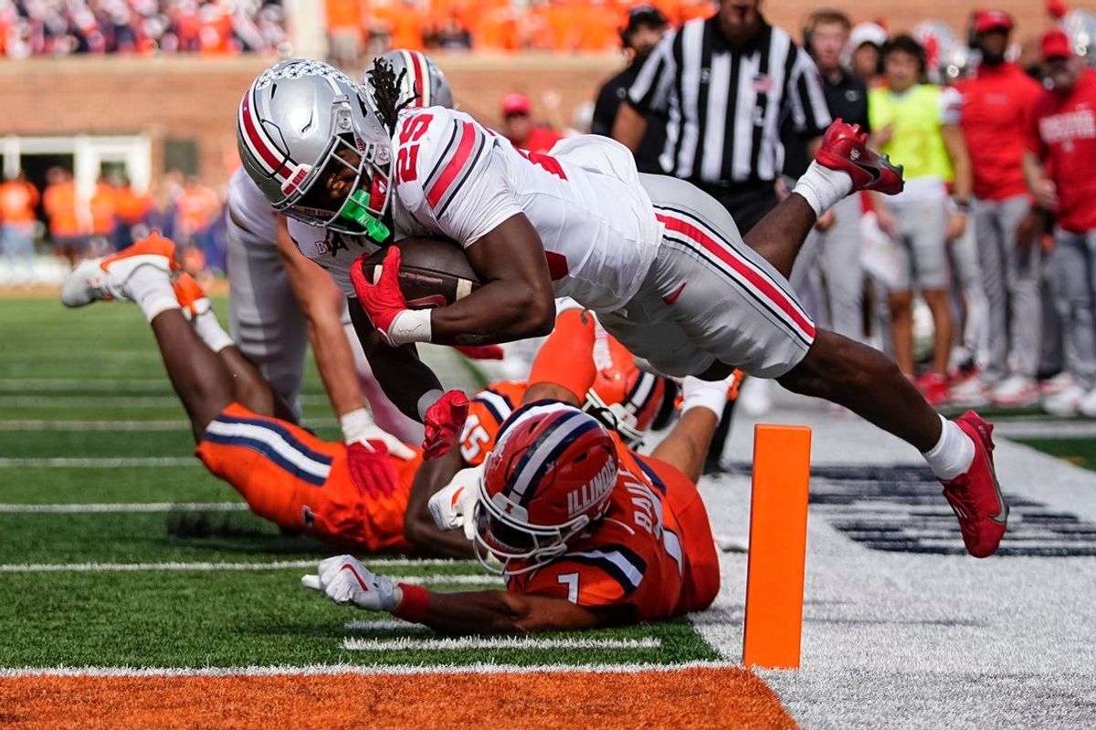Ohio State Buckeyes running back Bo Jackson (25) scores a touchdown over Illinois Fighting Illini defensive back Matthew Bailey (7) during the first half of the NCAA football game at Gies Memorial Stadium in Champaign on Oct. 11, 2025.