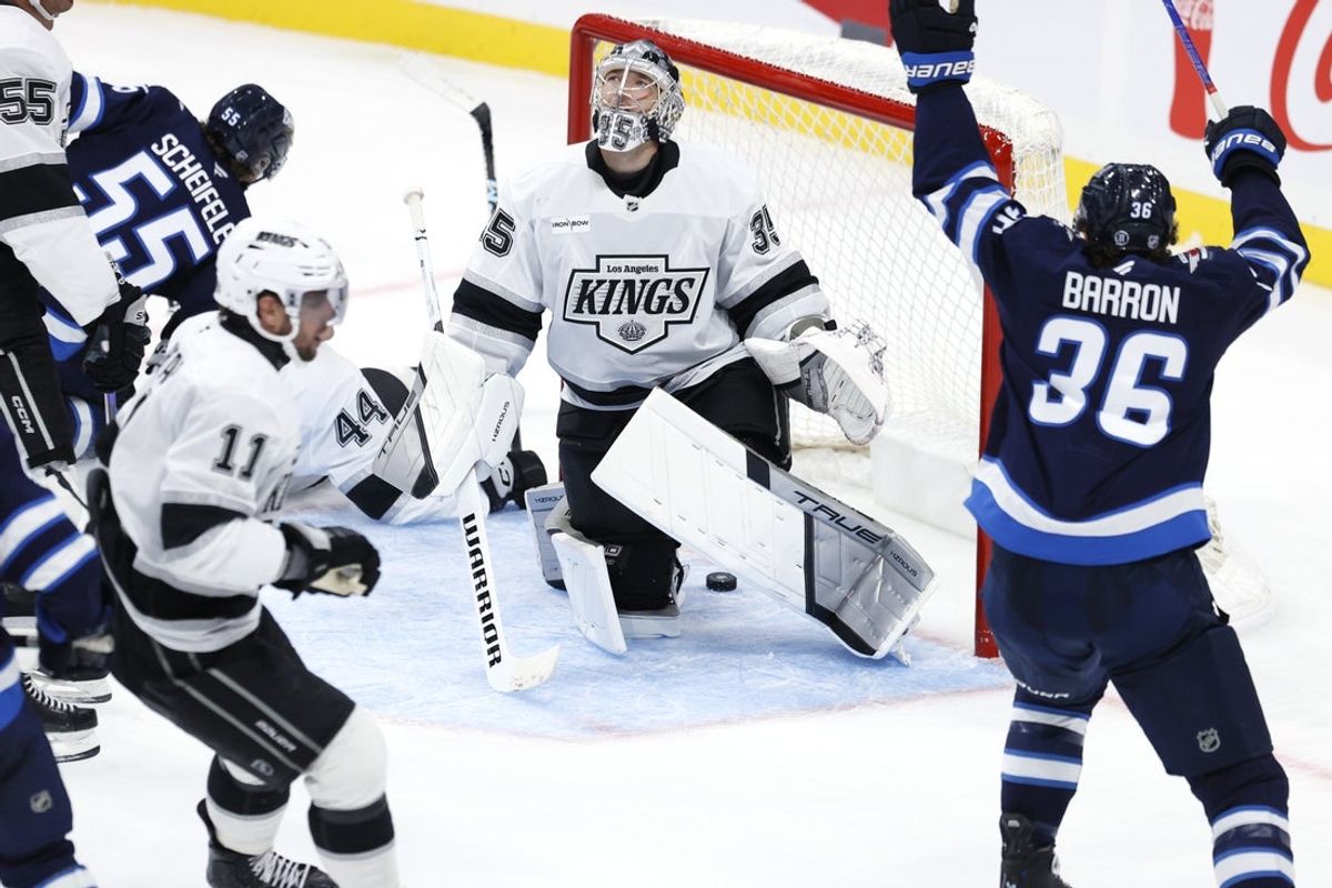 Oct 11, 2025; Winnipeg, Manitoba, CAN; Winnipeg Jets center Morgan Barron (36) celebrates a goal by center Mark Scheifele (55) on Los Angeles Kings goaltender Darcy Kuemper (35) in the second period at Canada Life Centre. Mandatory Credit: James Carey Lauder-Imagn Images