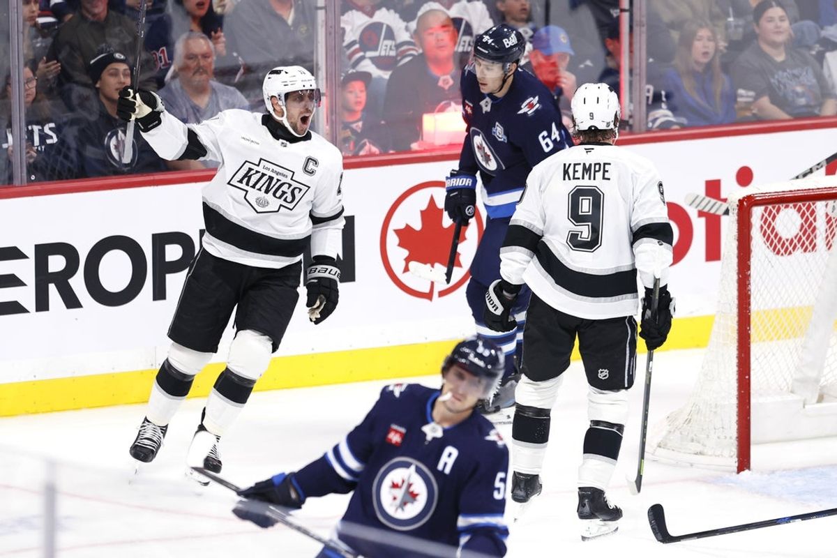 Oct 11, 2025; Winnipeg, Manitoba, CAN; Los Angeles Kings center Anze Kopitar (11) celebrates a goal by right wing Adrian Kempe (9) against the Winnipeg Jets in the second period at Canada Life Centre. Mandatory Credit: James Carey Lauder-Imagn Images