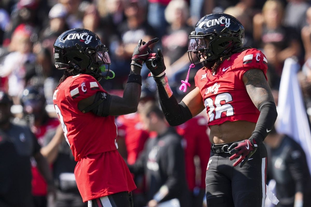 Oct 11, 2025; Cincinnati, Ohio, USA; Cincinnati Bearcats defensive back Jiquan Sanks (9) celebrates a play with safety Xavier Williams (36) in the game against the UCF Knights in the second half at Nippert Stadium. Mandatory Credit: Aaron Doster-Imagn Images