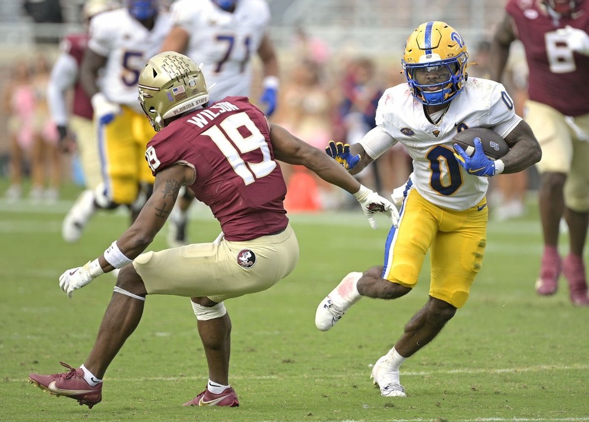 Oct 11, 2025; Tallahassee, Florida, USA; Pittsburgh Panthers running back Desmond Reid (0) runs the ball past Florida State Seminoles defensive back Jerry Wilson (19) during the second half at Doak S. Campbell Stadium. Mandatory Credit: Melina Myers-Imagn Images