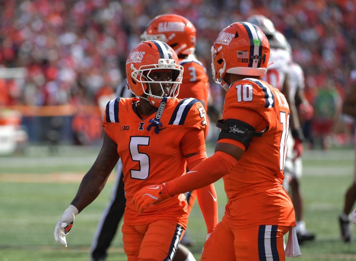 Oct 11, 2025; Champaign, Illinois, USA; Illinois Fighting Illini defensive back Torrie Cox Jr. (5) and defensive back Miles Scott (10) react during the second half against the Ohio State Buckeyes at Memorial Stadium. Mandatory Credit: Ron Johnson-Imagn Images